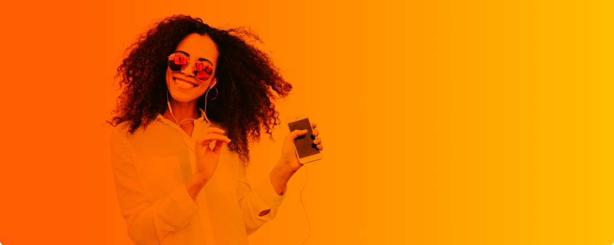 Nach einem erfolgreichem Handytarife Vergleich hört eine junge Frau Musik auf ihrem Smartphone.